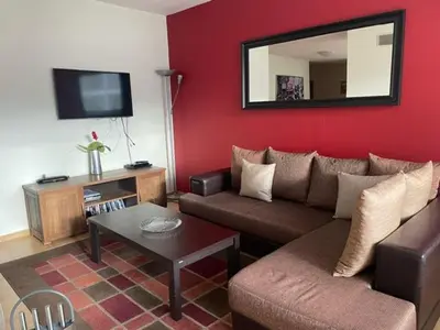 a living room with a couch and a mirror at 27 Monastery in Bansko