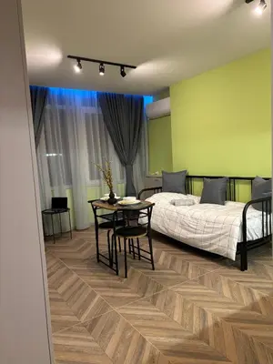 a bedroom with a bed and a table and chairs at Inspiration Nook in Sofia