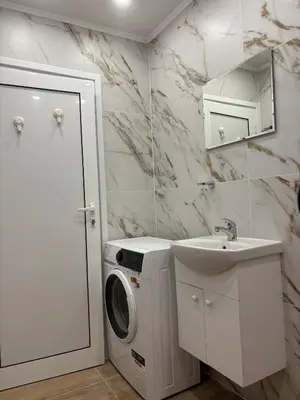 a bathroom with a washing machine and a sink at Inspiration Nook in Sofia