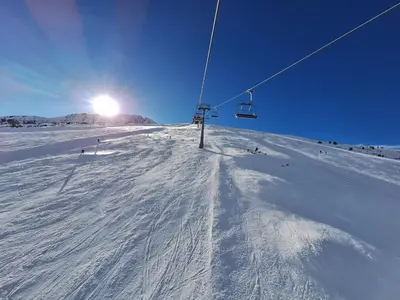 a ski lift on top of a snow covered slope at Slopes View Private Apartment - Luxury SPA in the 4-Star St Ivan Rilski Complex in Bansko
