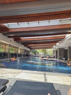 a large swimming pool with people in it at Slopes View Private Apartment - Luxury SPA in the 4-Star St Ivan Rilski Complex in Bansko