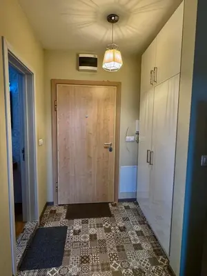 a hallway with a door and a tile floor at New Bulgarian Apartment in Sofia