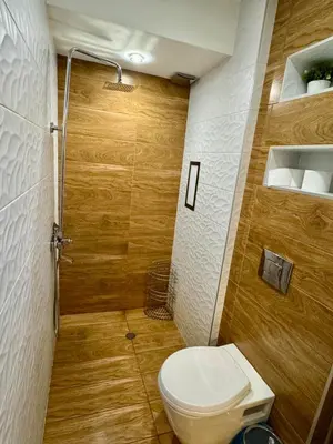 a bathroom with a toilet and a shower at New Bulgarian Apartment in Sofia