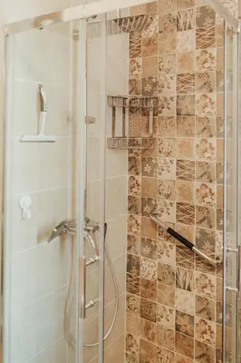a bathroom with a shower with a glass door at Apartment Aria 2 in Velingrad