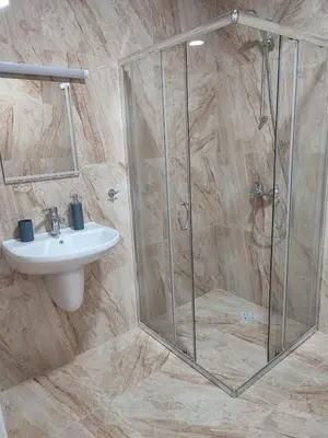 a bathroom with a shower and a sink at Pana Green Residence in Panagyurishte