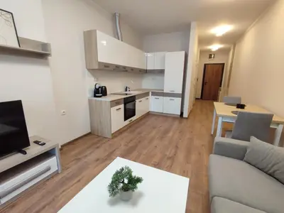 a kitchen and living room with a couch and a table at Pana Green Residence in Panagyurishte