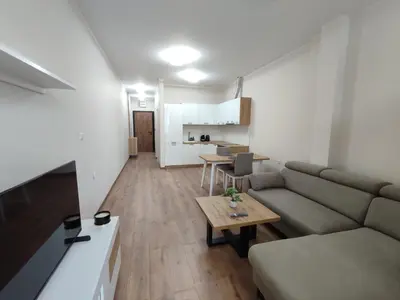 a living room with a couch and a table at Pana Green Residence in Panagyurishte