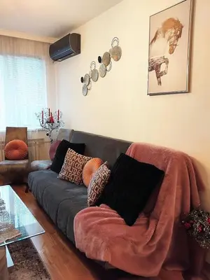 a living room with a couch with pillows on it at Art Apart - Top Center in Sofia