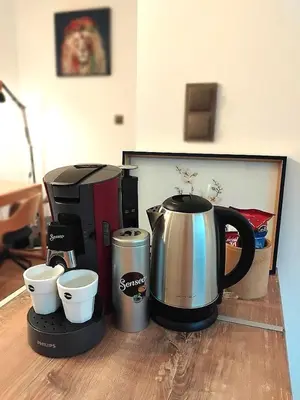 a coffee maker and coffeemaker sitting on a table at Art Apart - Top Center in Sofia