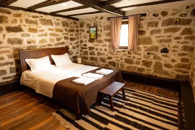 a bedroom with a bed with towels on it at Гусу Баба in Kostenets Village