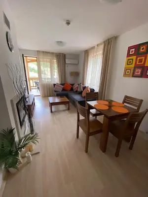 a living room with a couch and a table at St John Hill Alexander Services Apartments in Bansko