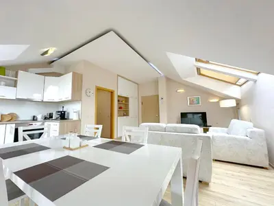 a kitchen and living room with a white table and chairs at Old City Views - Luxury 2BDR Apt & Free Parking in Sofia