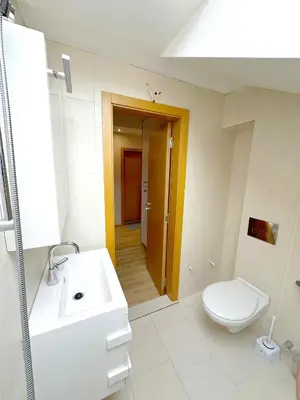 a bathroom with a white toilet and a sink at Old City Views - Luxury 2BDR Apt & Free Parking in Sofia