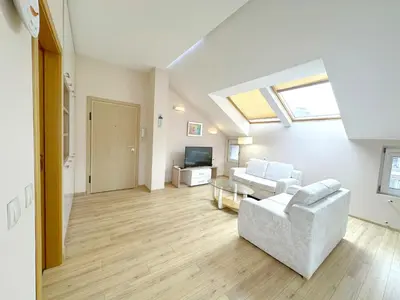 a living room with a couch and a tv at Old City Views - Luxury 2BDR Apt & Free Parking in Sofia