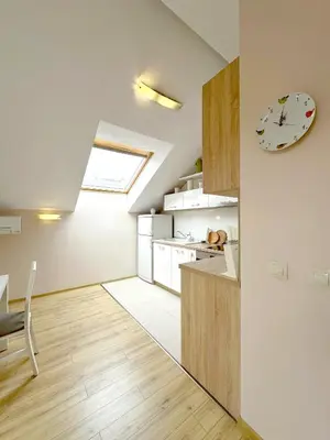 a kitchen with a table and a clock on the wall at Old City Views - Luxury 2BDR Apt & Free Parking in Sofia