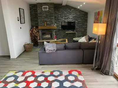 a living room with a couch and a fireplace at Elegant 3 Alexander Services Apartments luxury four bedroom penthouse in Bansko