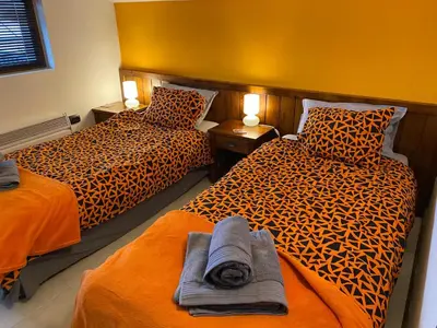 two beds sitting next to each other in a room at Elegant 3 Alexander Services Apartments luxury four bedroom penthouse in Bansko