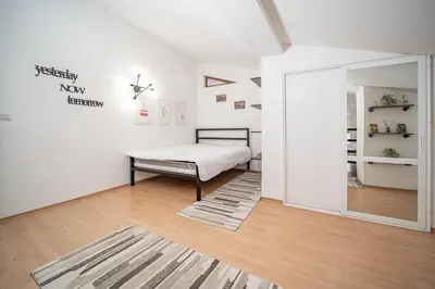 a white room with a bed and a mirror at CrosswayBg Pamporovo in Pamporovo