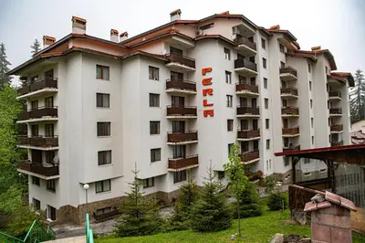 a large white building with a hotel sign on it at CrosswayBg Pamporovo in Pamporovo