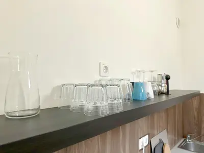 a row of glasses sitting on a shelf at Echoes of Comfort - Top Center 1 BDR Fast Wi-fi in Sofia