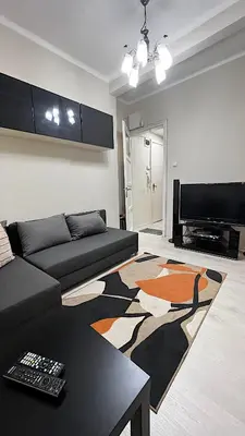 a living room with a couch and a rug at Great location in the Center in Sofia