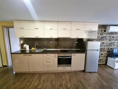 a kitchen with white cabinets and a sink and a refrigerator at Fast Wi-Fi, Kitchen, In Sofia in Sofia