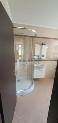 a bathroom with a shower and a sink at GONDOLA APARTMENTS BANSKO - SUVOROV VIP Complex in Bansko