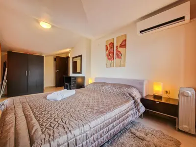 a bedroom with a large bed in a room at Glazne River View - 2BDR & 2BTHR Flat with a View by Flat Mаnager in Bansko