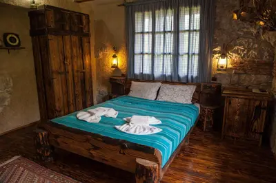 a bedroom with a bed with towels on it at Самостоятелна къща за гости с изглед към планината Вила Марк in Kraevo