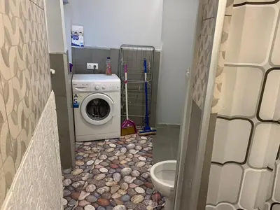 a bathroom with a washing machine and a toilet at Southern Hill in Sofia