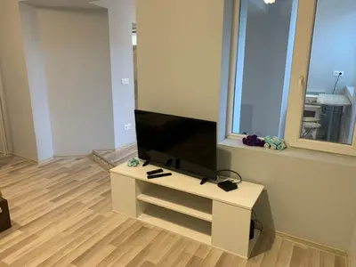 a living room with a flat screen tv on a table at Southern Hill in Sofia