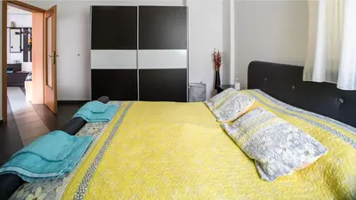 a bedroom with a large bed with two pillows on it at Best Location in Sofia Center in Sofia