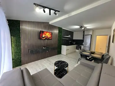 a living room with a couch and a dining room at Nikos Apatament in Velingrad
