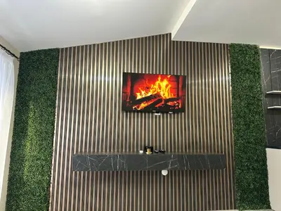 a tv on a wall with a fire on it at Nikos Apatament in Velingrad