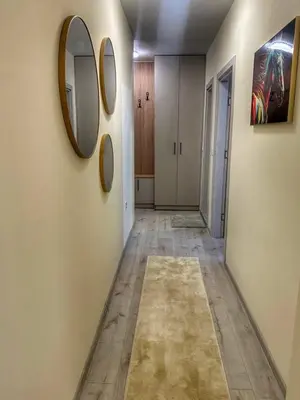 a hallway with a mirror on the wall at Nikos Apatament in Velingrad