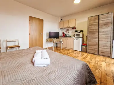 a bedroom with a bed with two towels on it at Mountain View Studio, Steps from Bansko Gondola by Flat Mаnager in Bansko