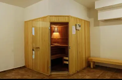a wooden cabinet with a lamp in a room at Mountain View Studio, Steps from Bansko Gondola by Flat Mаnager in Bansko