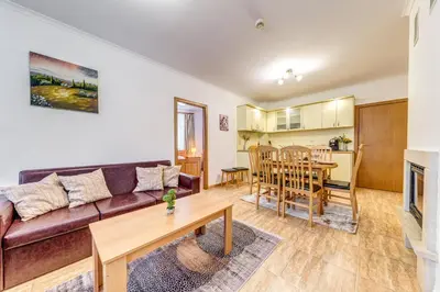 a living room with a couch and a table at Alpine Haven 2-Bedroom Escape, Pamporovo by Flat Mаnager in Pamporovo