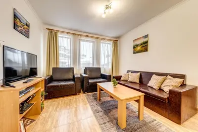 a living room with a couch and a tv at Alpine Haven 2-Bedroom Escape, Pamporovo by Flat Mаnager in Pamporovo