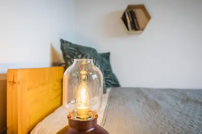 a glass jar with a light on top of a bed at Cozy Luxurious Apartment Next to Borovets and Rila mountain in Govedartsi