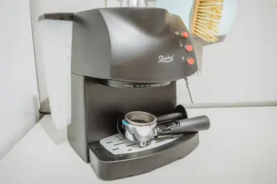 a coffee maker with a cup on top of it at Cozy Luxurious Apartment Next to Borovets and Rila mountain in Govedartsi