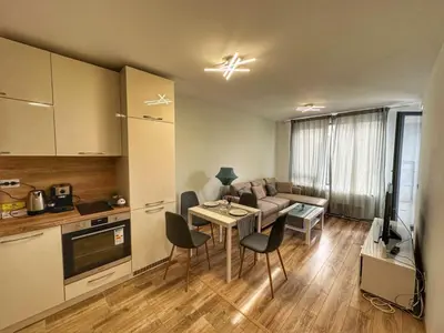 a living room with a couch and a table with chairs at 5 min from the Airport in Sofia