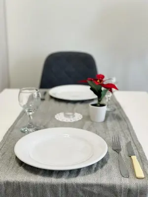 a table with a white plate and a fork and knife at 5 min from the Airport in Sofia