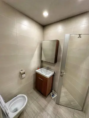 a bathroom with a toilet and a sink and a mirror at 5 min from the Airport in Sofia