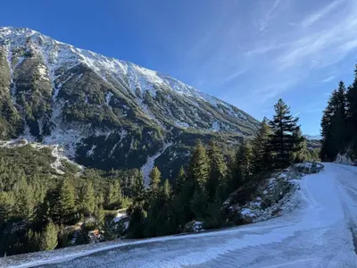 a snow covered mountain with trees and a road at La Mont Apartment Bansko in Bansko