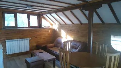 a living room with a couch and a table at Tora Bora Guest House in Pancharevo