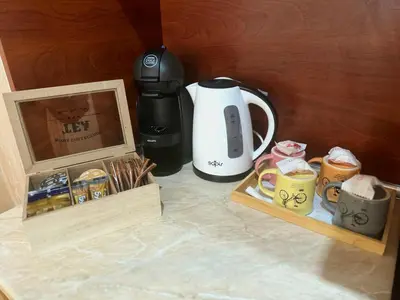 a coffeemaker and a coffee maker sitting on a counter at Raya Apart Pamporovo in Pamporovo