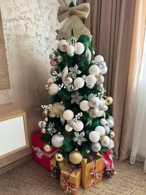 a christmas tree with ornaments on it at Raya Apart Pamporovo in Pamporovo