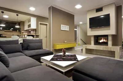 a living room with a couch and a fireplace at Anita Guest House & Relax in Perushtitsa