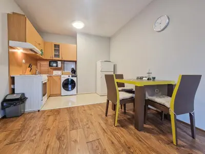 a kitchen and dining room with a table and chairs at Charming Mont Blanc Bansko Apartment Near Ski Lift by Flat Mаnager in Bansko
